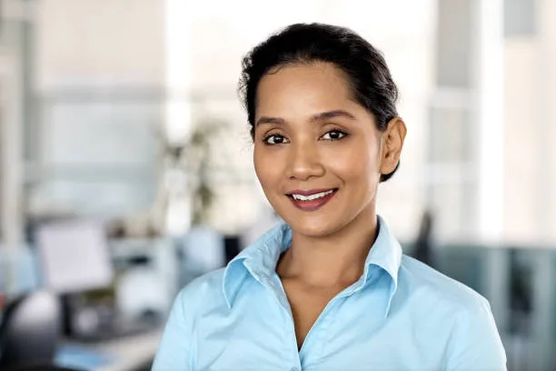 gettyimages-965602024-612×612 Portrait of young businesswoman smiling. Confident female professional is in office. She is wearing formal shirt.